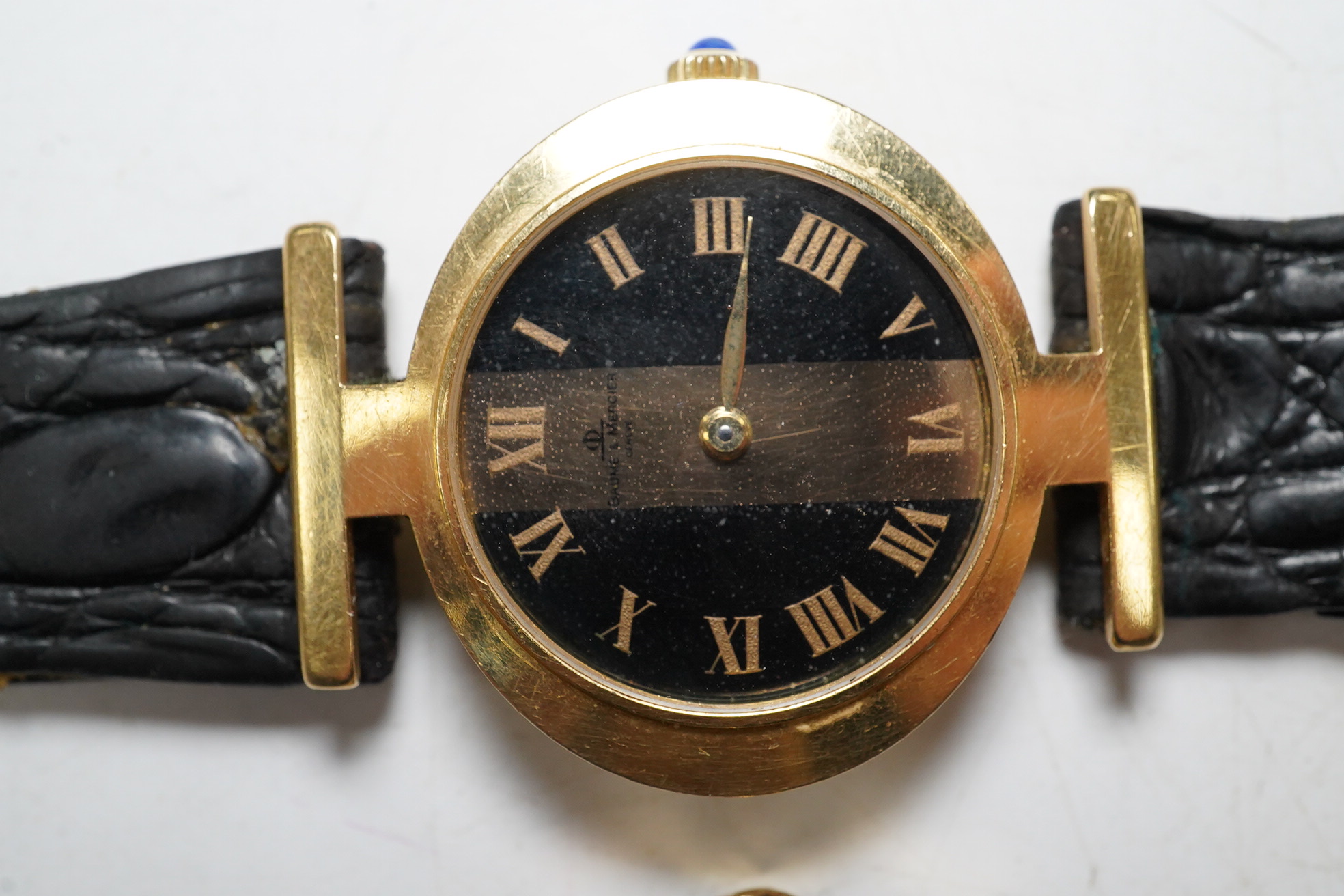 A ladies stylish Baume Mercier 18ct gold wrist watch, in original green leather case, and two gold plated wrist watches by Omega and Bucherer. Condition - Baume Mercier movement not going, later strap with gold plated bu